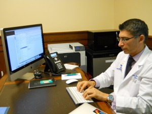 Dr. Fred Poordad, lead author on a study that found a cure for Hepatitis C, works in his office at the Texas Liver Institute April 16, 2014. Eileen Pace TPR News